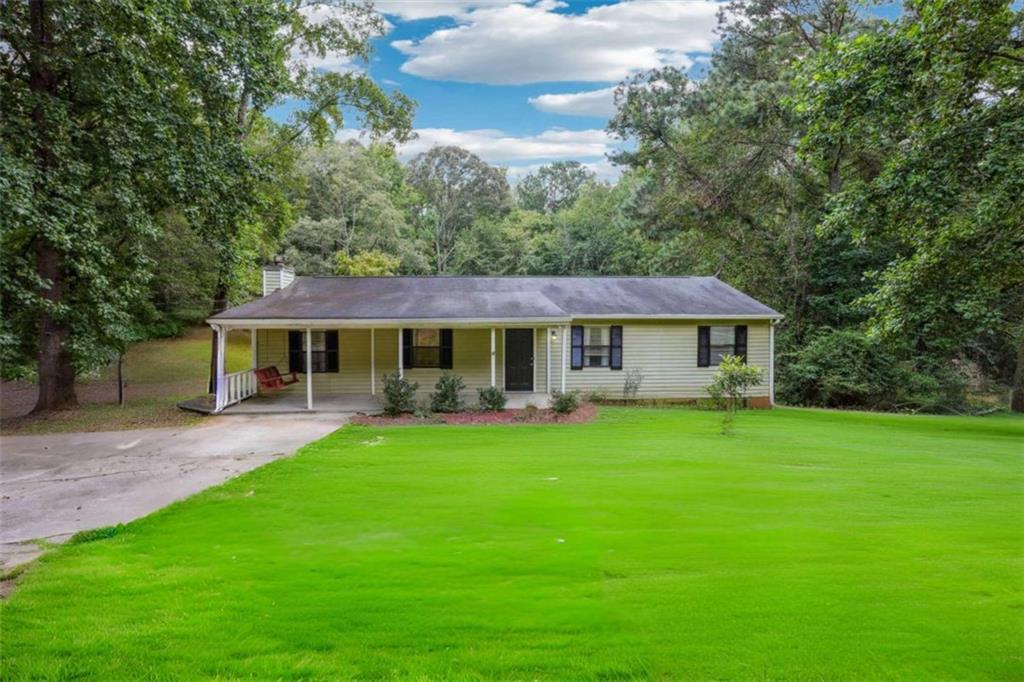 183 Elm Street Covington, GA 30014 - Photo 3 of 23 a front view of a house with garden