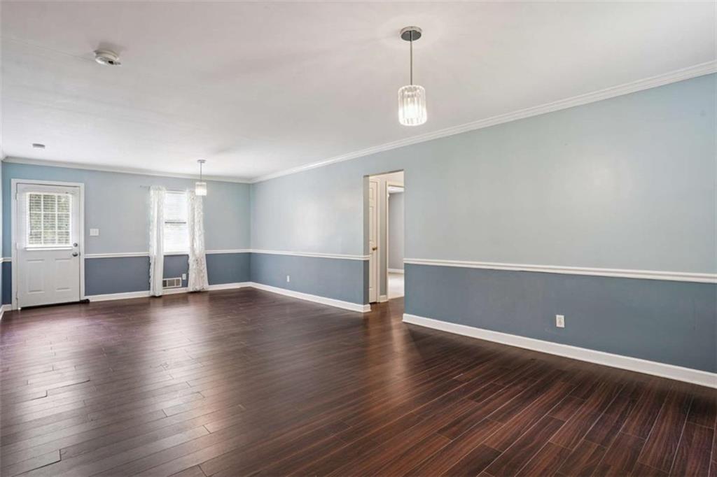 183 Elm Street Covington, GA 30014 - Photo 7 of 23 a view of empty room with wooden floor