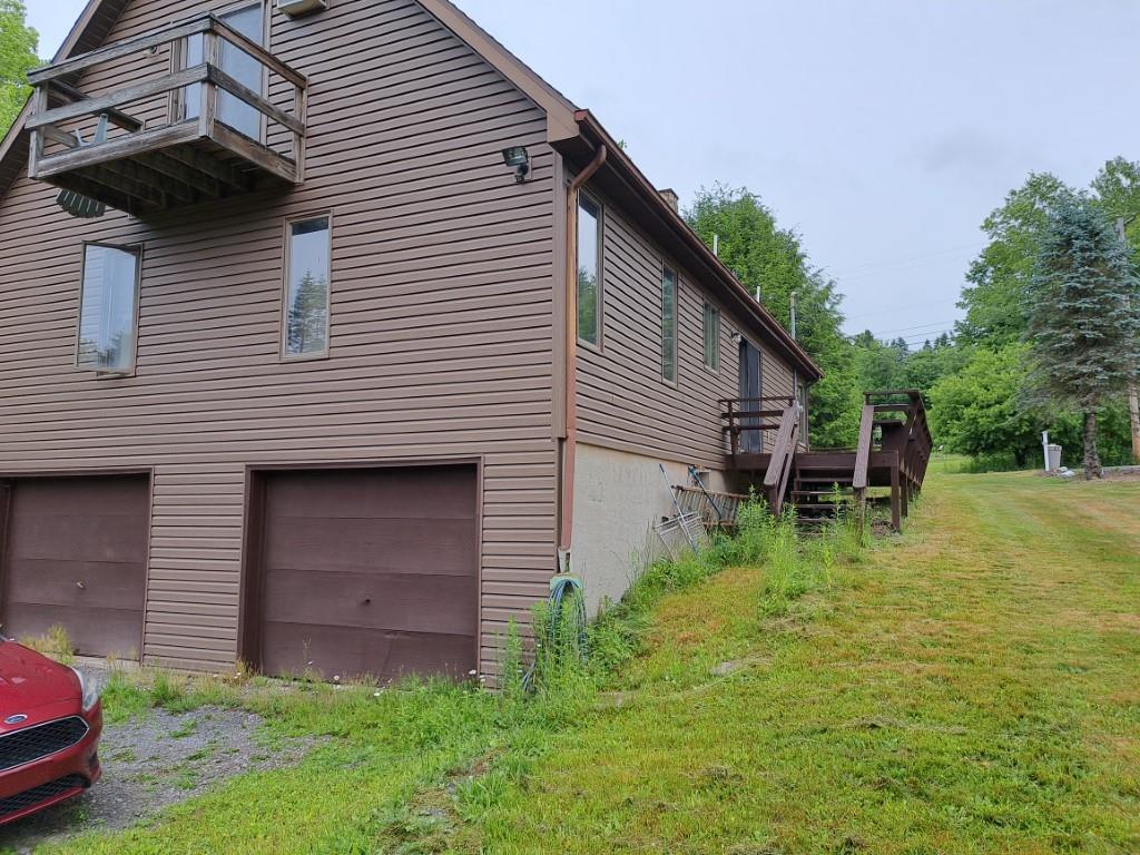 a backyard of a house with plants and outdoor seating