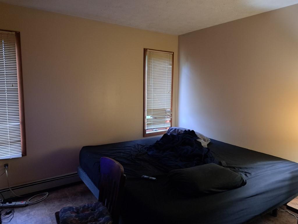 337 Pine Street Kane, PA 16735 - Photo 9 of 14 a bed sitting in a bedroom next to a window