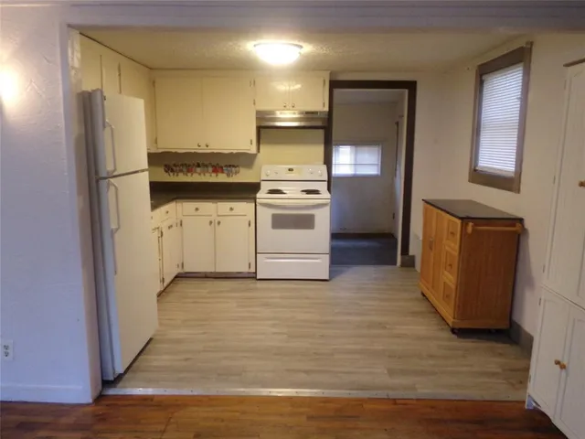 a kitchen with a refrigerator and a stove