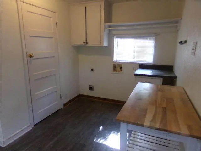 a view of a room with wooden floor and windows
