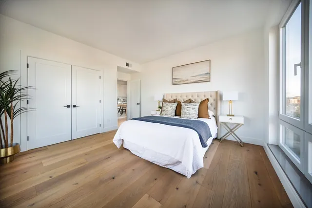 a bedroom with a bed and a potted plant