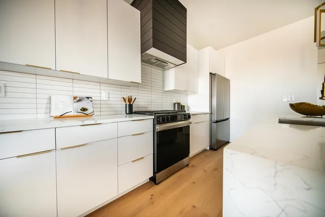 a kitchen with a sink appliances and cabinets