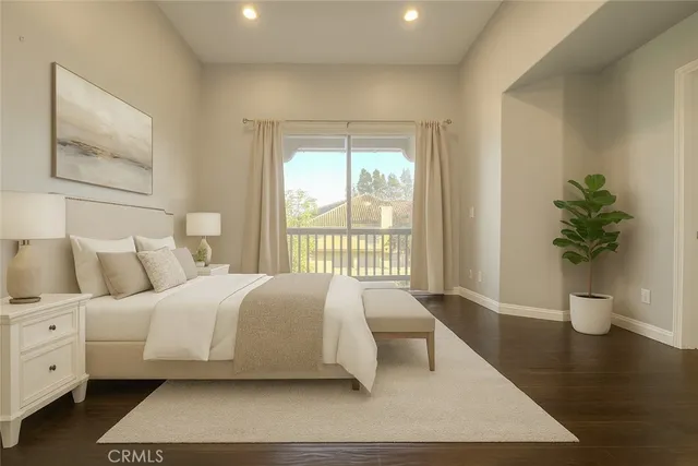 a bedroom with a large bed and a potted plant