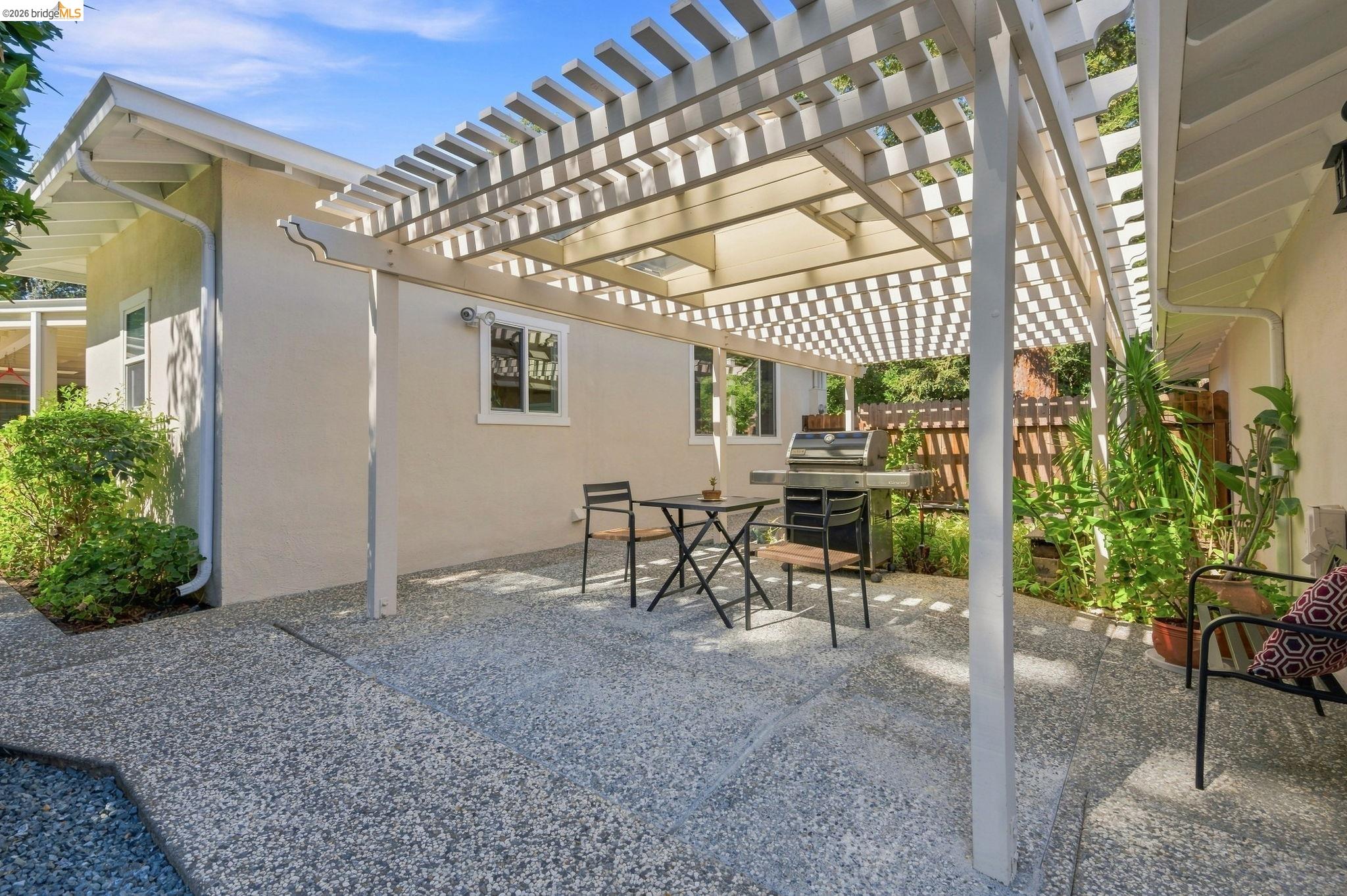 5075 Alhambra Valley Road Martinez, CA 94553 - Photo 42 of 68 Exterior patio with an open lattice pergola and exposed aggregate concrete surfacing