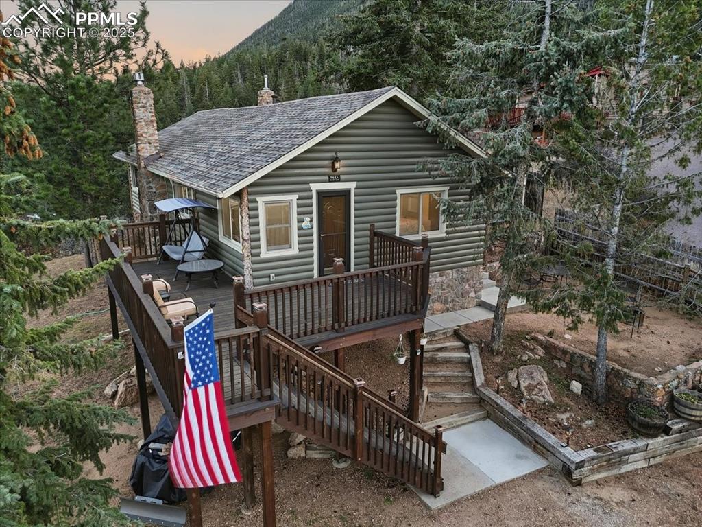 9445 Mohawk Trail Cascade, CO 80809 - Photo 1 of 47 a view of backyard with roof deck and wooden floor