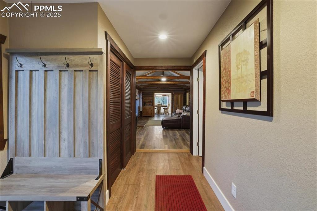9445 Mohawk Trail Cascade, CO 80809 - Photo 11 of 47 a view of a hallway with wooden floor and staircase