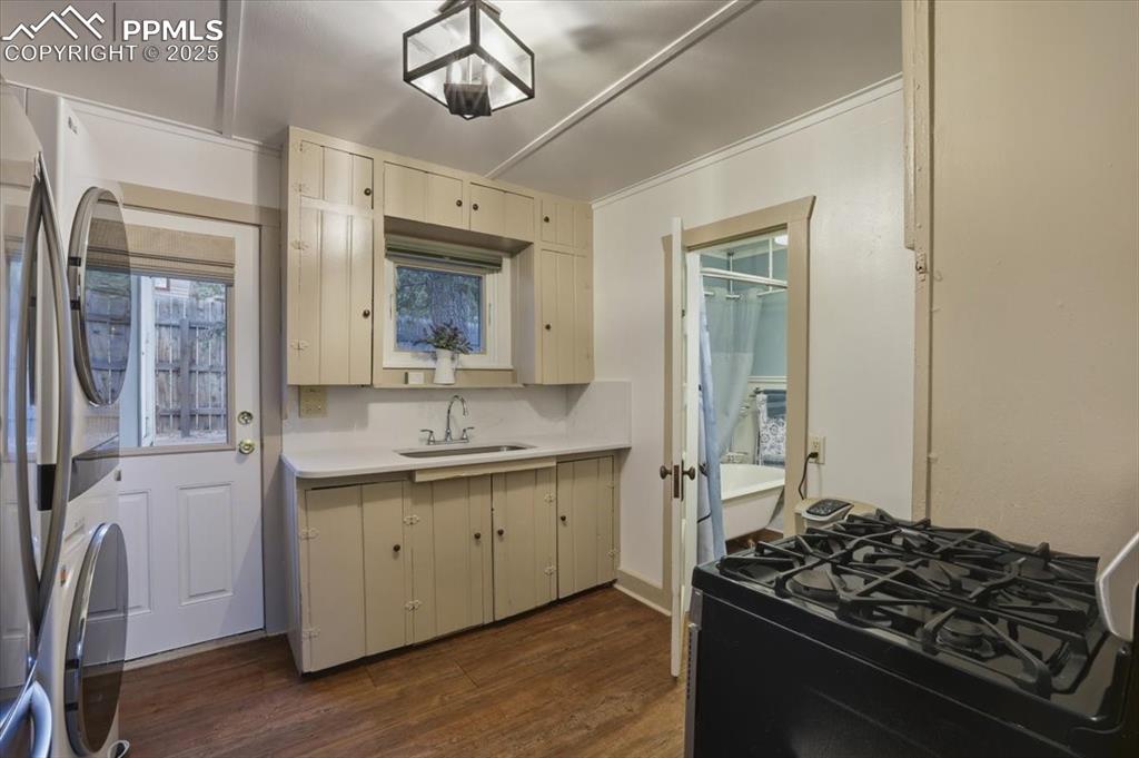 9445 Mohawk Trail Cascade, CO 80809 - Photo 15 of 47 a kitchen with a sink stove and cabinets