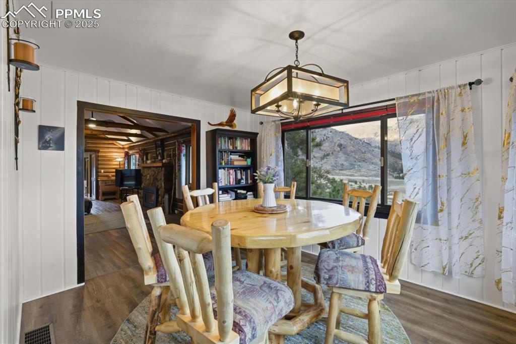 9445 Mohawk Trail Cascade, CO 80809 - Photo 21 of 47 a view of a dining room with furniture window and wooden floor