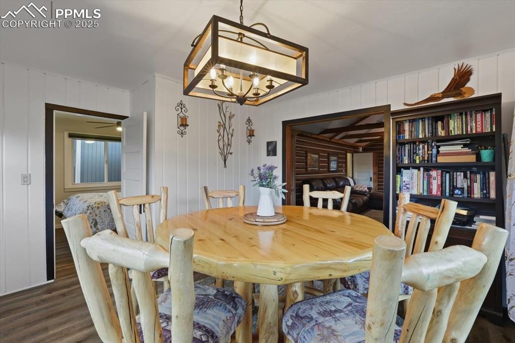 9445 Mohawk Trail Cascade, CO 80809 - Photo 23 of 47 a view of a dining room with furniture and a chandelier