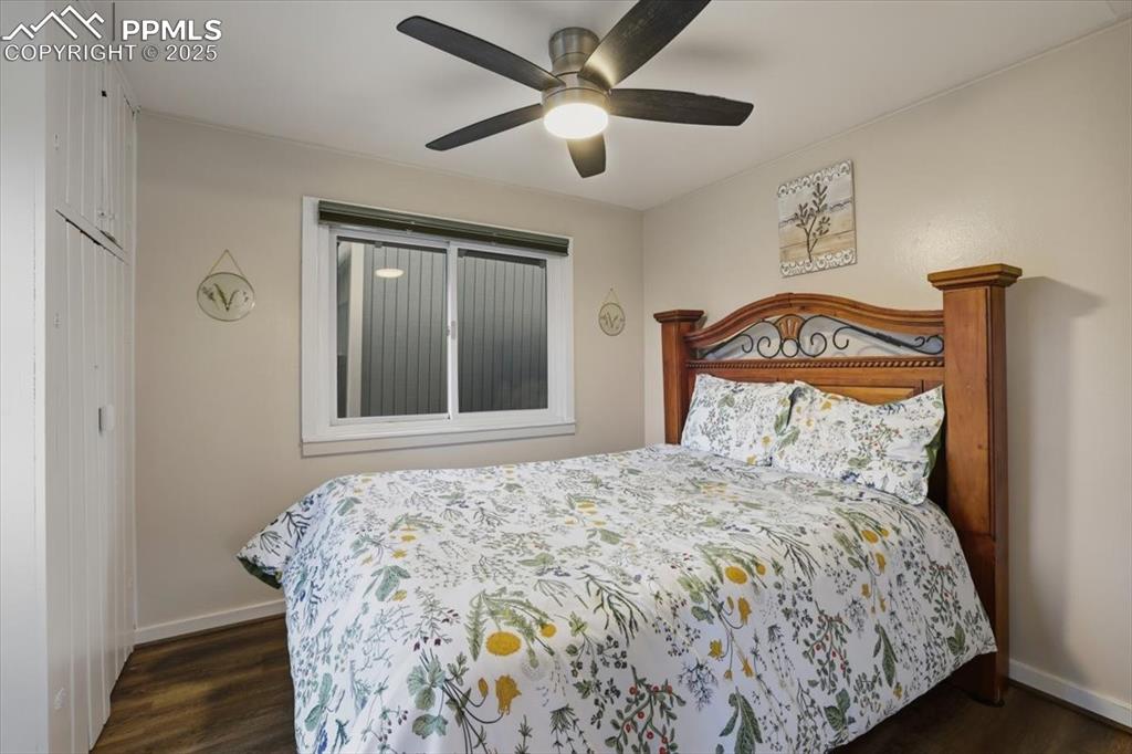 9445 Mohawk Trail Cascade, CO 80809 - Photo 24 of 47 a bedroom with a bed and a chandelier