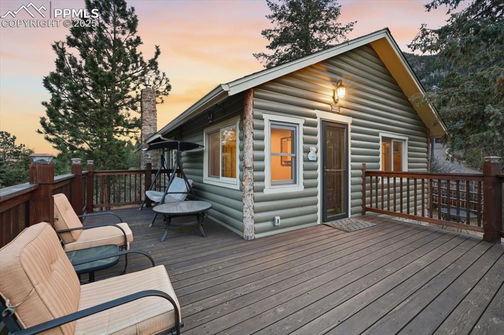 9445 Mohawk Trail Cascade, CO 80809 - Photo 3 of 47 a view of a wooden deck with furniture