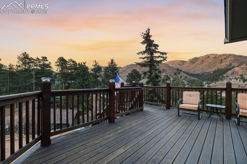 9445 Mohawk Trail Cascade, CO 80809 - Photo 4 of 47 a view of a balcony with wooden floor and city view