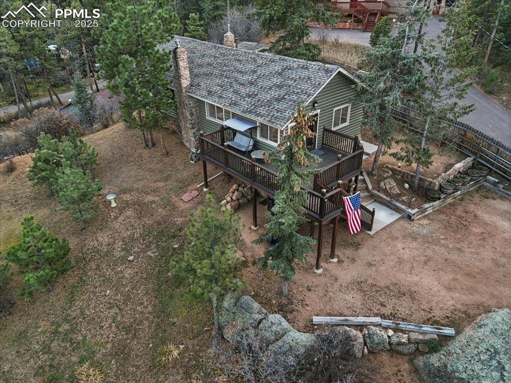 9445 Mohawk Trail Cascade, CO 80809 - Photo 44 of 47 a backyard of a house with table and chairs