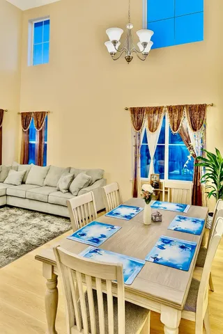 a living room with furniture and a open kitchen view
