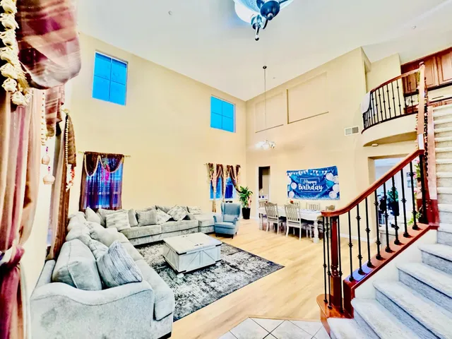 a living room with furniture and a chandelier
