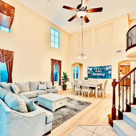 a living room with furniture a rug and a flat screen tv