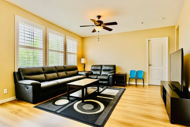 a bedroom with a bed and ceiling fan