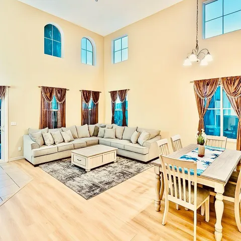 a living room with furniture and wooden floor