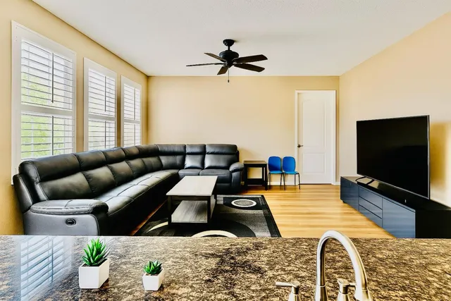 a living room with furniture and a flat screen tv