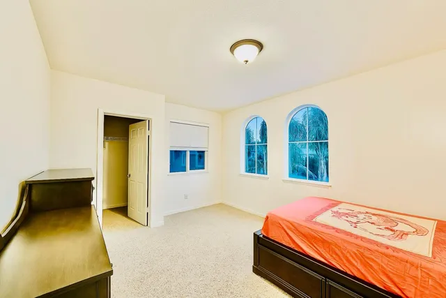 a kitchen with a dining table chairs stove and granite counter top