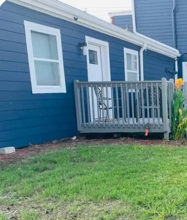 a view of a backyard with wooden fence