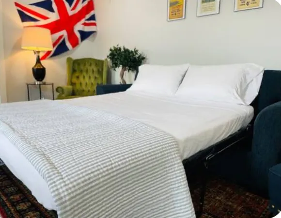 a bedroom with a bed and potted plant