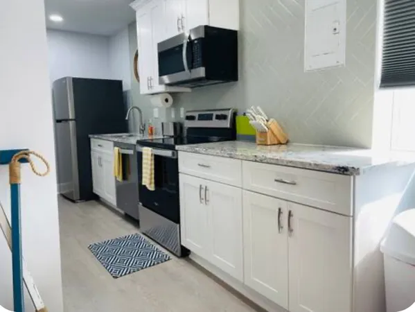 a kitchen with stainless steel appliances granite countertop a refrigerator stove and microwave