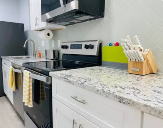 a kitchen with stainless steel appliances granite countertop a sink and stove