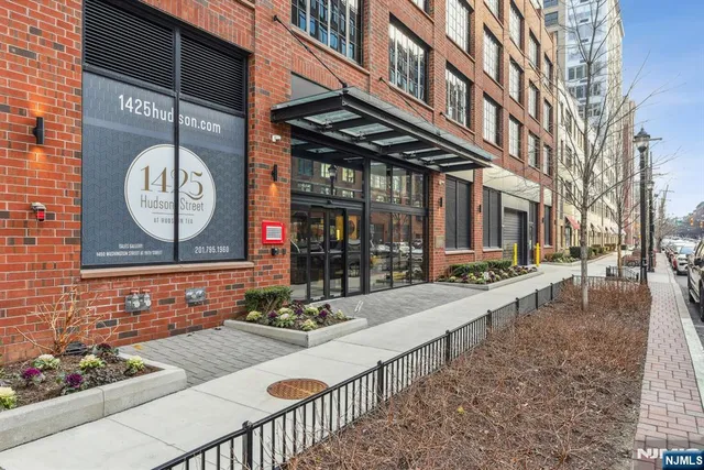 a view of a brick house with large windows