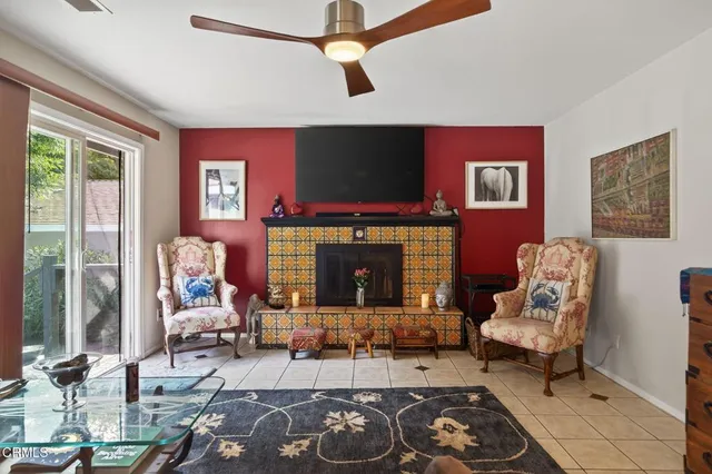 a living room with furniture a flat screen tv and a fireplace
