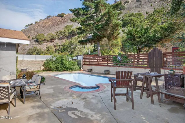 a view of a patio with table and chairs and potted plants