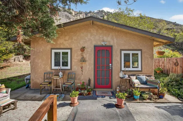 a backyard of a house with outdoor seating