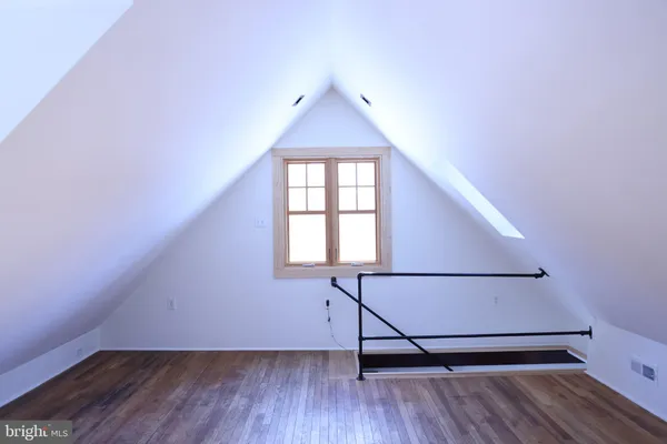 a view of hallway with wooden floor