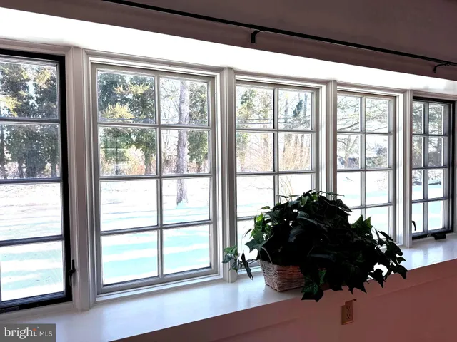 a bed room with a bed and a large window