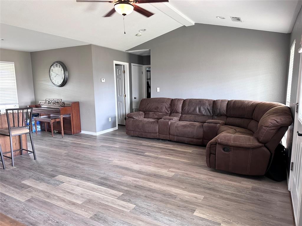 12638 Highway 82 Savoy, TX 75479 - Photo 14 of 21 a living room with furniture and a wooden floor