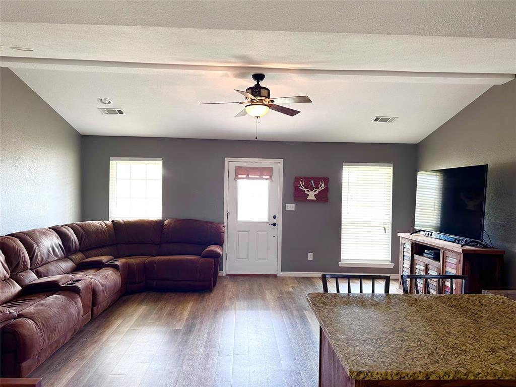 12638 Highway 82 Savoy, TX 75479 - Photo 16 of 21 a living room with furniture and a flat screen tv