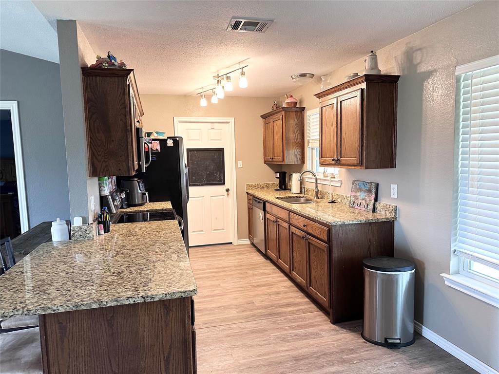12638 Highway 82 Savoy, TX 75479 - Photo 17 of 21 a large kitchen with kitchen island granite countertop a large counter top appliances and cabinets