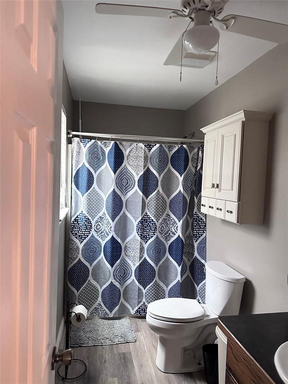 12638 Highway 82 Savoy, TX 75479 - Photo 3 of 21 a bathroom with a toilet and a shower curtain