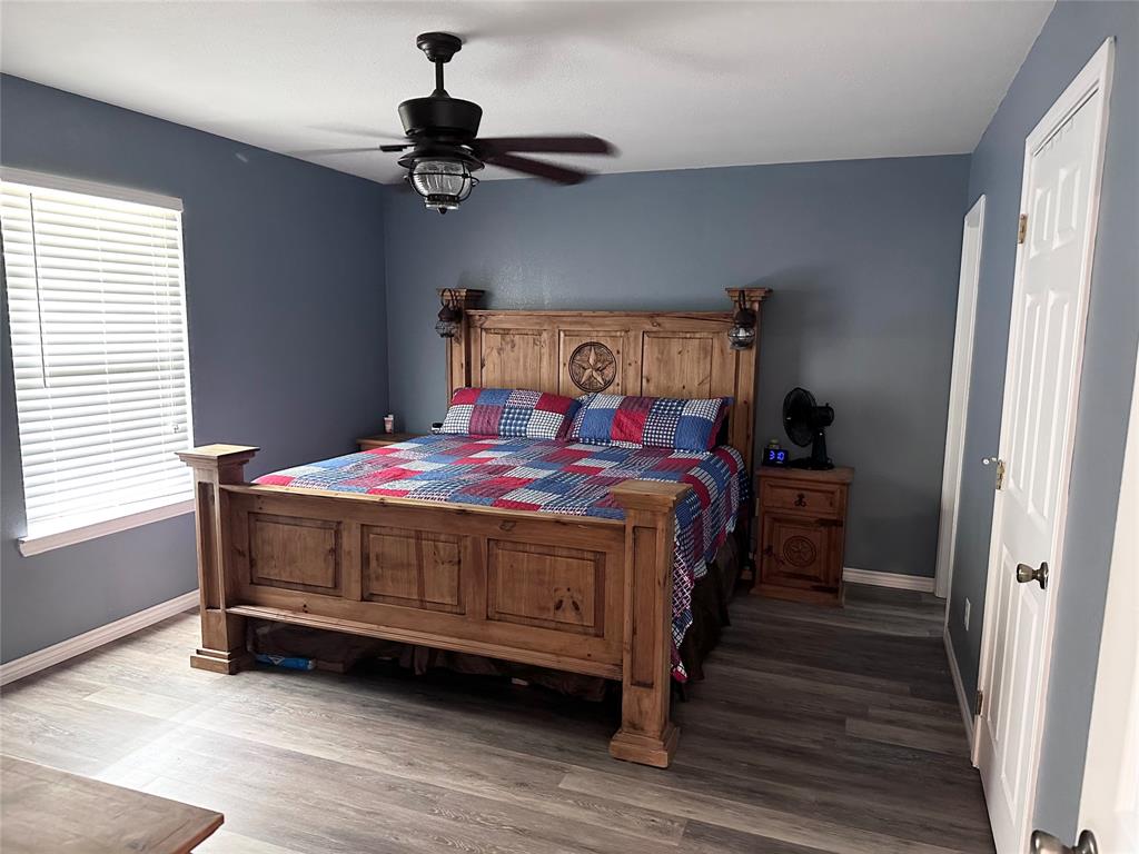 12638 Highway 82 Savoy, TX 75479 - Photo 4 of 21 a bedroom with a bed and a chandelier