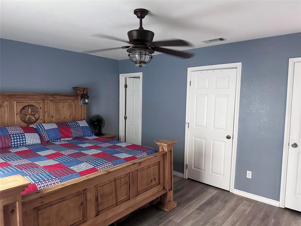 12638 Highway 82 Savoy, TX 75479 - Photo 5 of 21 a bedroom with a bed and a chandelier