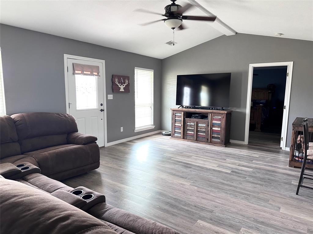 12638 Highway 82 Savoy, TX 75479 - Photo 8 of 21 a living room with furniture and a flat screen tv