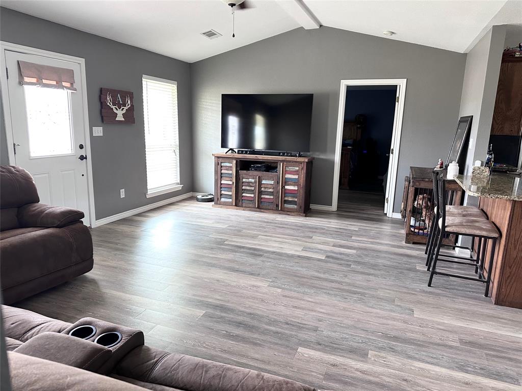 12638 Highway 82 Savoy, TX 75479 - Photo 9 of 21 a living room with furniture and a flat screen tv