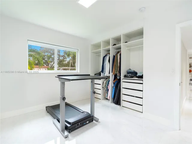 a room with gym equipment and a window