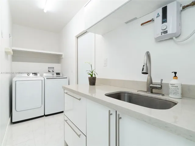 a kitchen with cabinets appliances and a sink