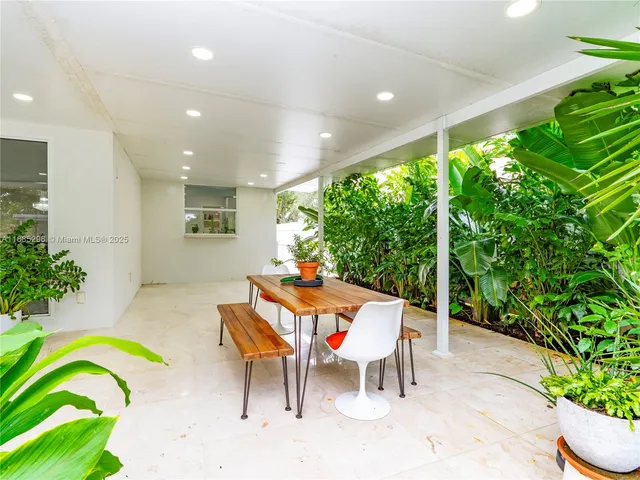 a outdoor space with a table and chairs