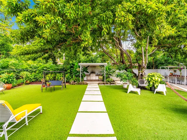 a view of a swimming pool with a table and chairs