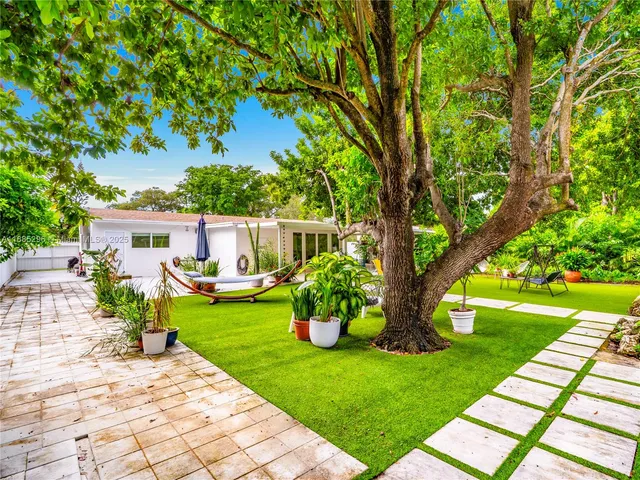 a front view of a house with garden and patio