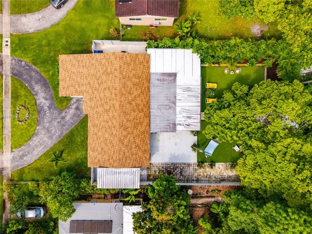 an aerial view of a house with a yard and outdoor seating